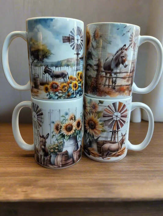 Set of four mugs with farm-themed designs on a wooden surface.