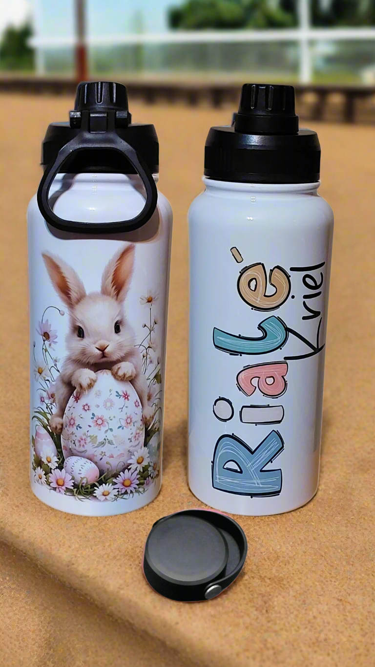 Two water bottles, one with a rabbit design and the other with 'Ria's World' text.