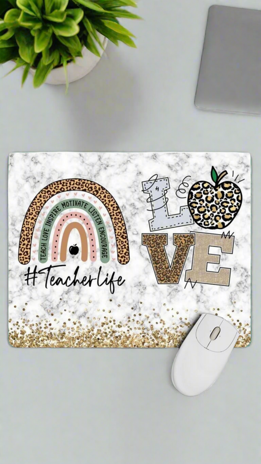 Decorative mouse pad with '#Teacherlife' text and colorful design on a white background